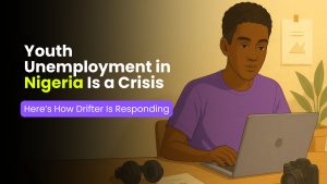 Illustration of a young Nigerian man working on a laptop with the text “Youth Unemployment in Nigeria Is a Crisis. Here’s How Drifter Is Responding” displayed on the left.